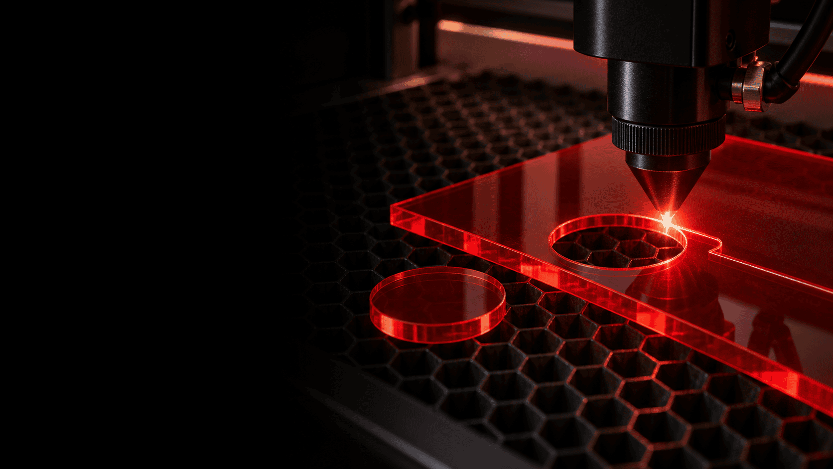 CO₂ laser processing transparent red cast acrylic on a honeycomb bed